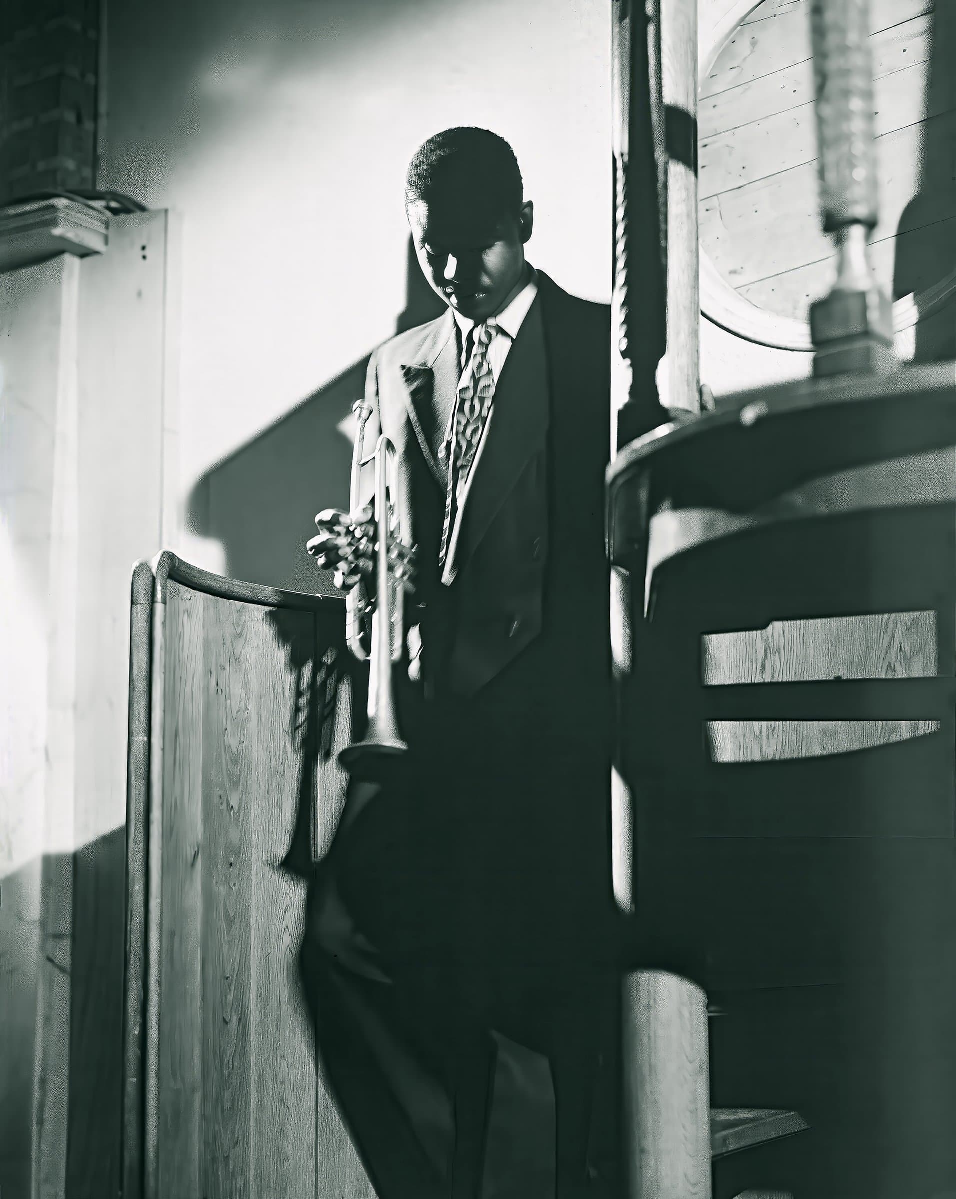 A trumpeter in a dark doorway